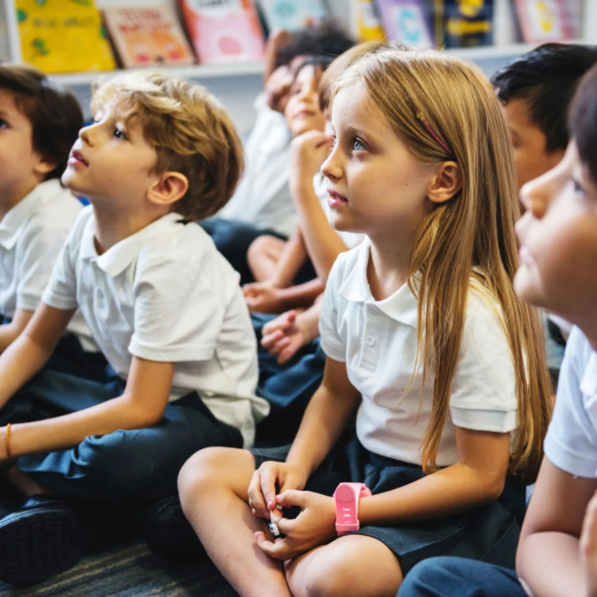 children sitting on the classroom floor