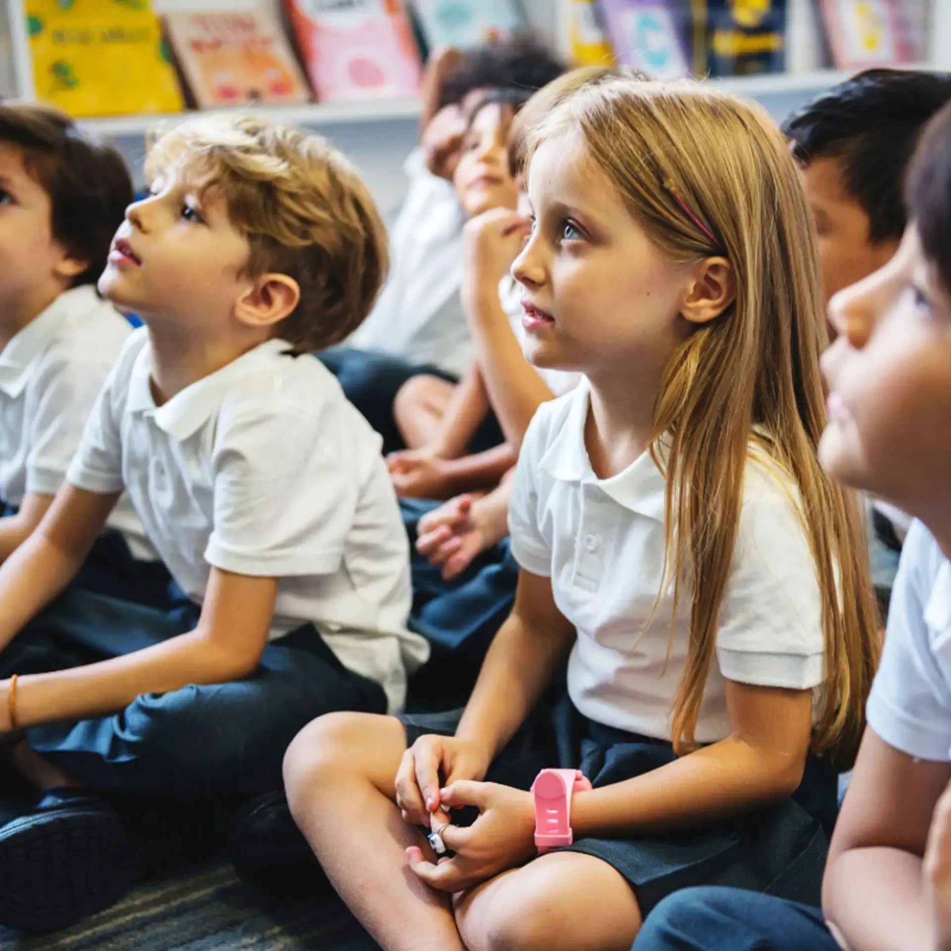 children sitting on the classroom floor